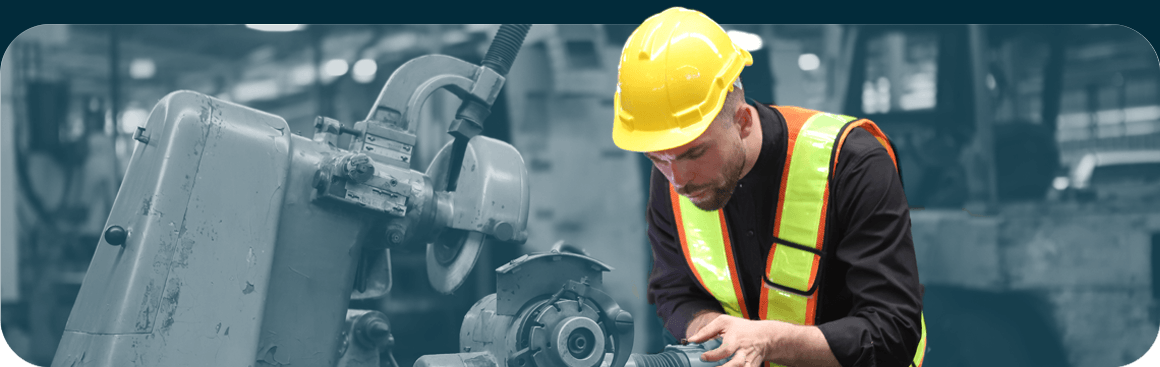 Woman in construction hat typing on tablet